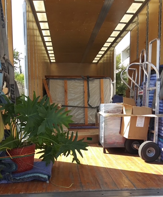 Properties carefully strapped and secured inside a KenMover box truck during non-local transport.